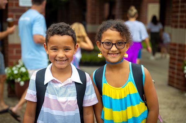 two students smiling in front of WGES